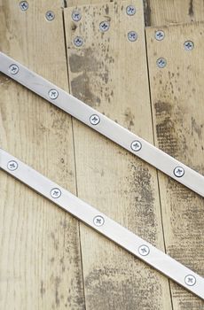 Wooden and metal screws, detail of a wood bonded metal, decoration and safety, textured background
