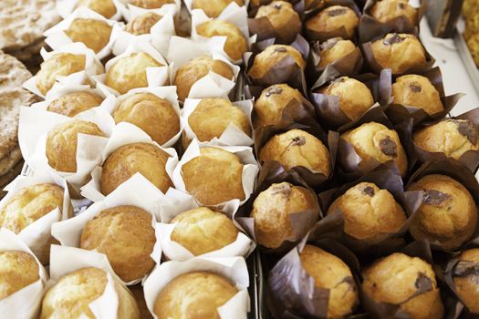 Homemade cupcakes in a market, detail of normal muffins and chocolate dessert