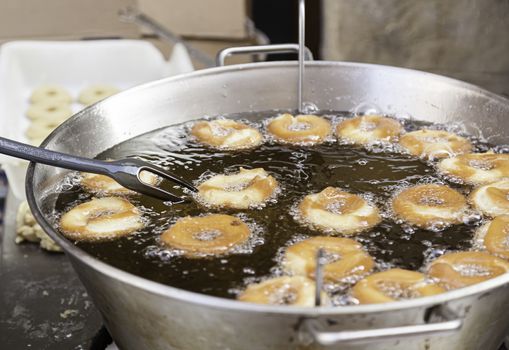 Frying donuts in the street, detail of a market, dessert, food for healthy life