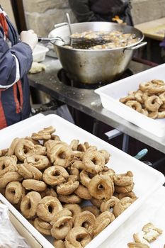 Frying donuts in the street, detail of a market, dessert, food for healthy life