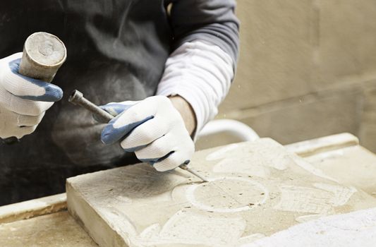 Man carving stone detail of a traditional craftsman working stone worker, crafts