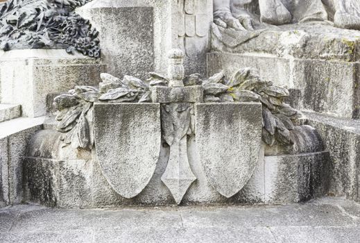 Statue with shield and sword, detail of a war memorial statue, art in the city