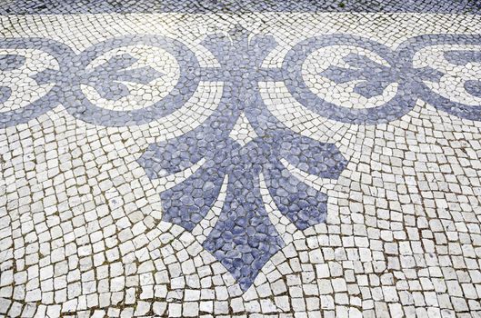 Lisbon typical mosaic, detail of a typical floor of Portugal, decorative mosaic on a typical street of Lisbon