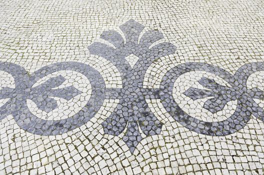 Lisbon typical mosaic, detail of a typical floor of Portugal, decorative mosaic on a typical street of Lisbon