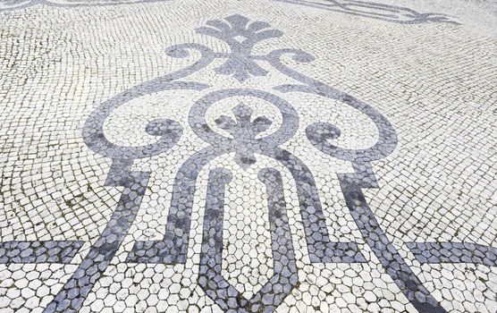 Lisbon typical mosaic, detail of a typical floor of Portugal, decorative mosaic on a typical street of Lisbon