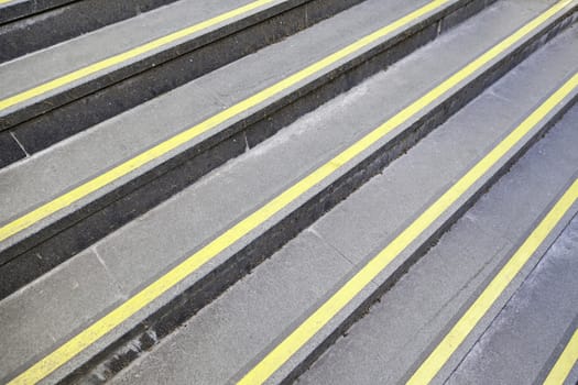 Steps with yellow signs, detail of stairs with protective signals