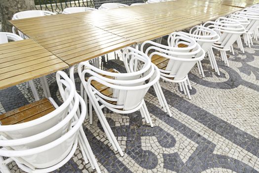 Terrace tables and chairs, detail of a land in a city street