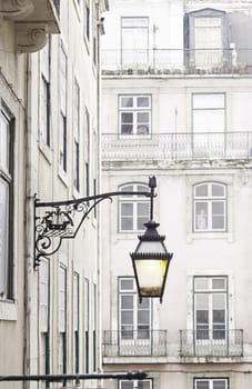 Old street lamp on a classical facade in Lisbon, detail of an old lighting in the city, Art and Tourism