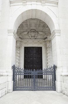 Ancient stone arch and wooden door, detail of an old door, safety and protection, monument