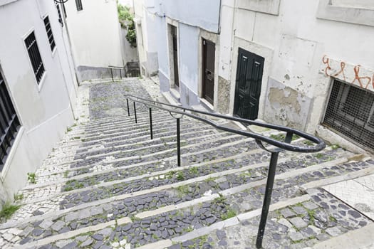 Old stone stairs in Lisbon, detail of stairs in an old street in an old neighborhood in Portugal
