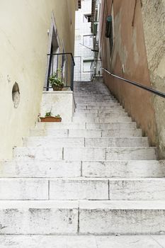 Old stone stairs in Lisbon, detail of stairs in an old street in an old neighborhood in Portugal
