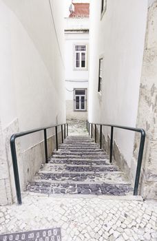 Old stone stairs in Lisbon, detail of stairs in an old street in an old neighborhood in Portugal