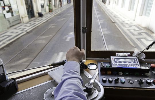Driver tram in Lisbon, detail of a person wearing an old tram travelers in Portugal
