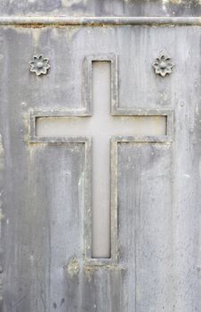 Old rusty metal cross, detail of an old cross on a metal wall, cemetery