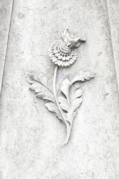 Old flower carved in stone, carved detail of a flower, stone art