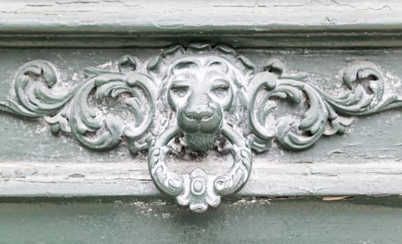 Caller shaped golden lion, detail of an ancient decorated door, ancient art