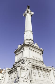 Stone statue in Lisbon, detail of a typical monument in Portugal, art