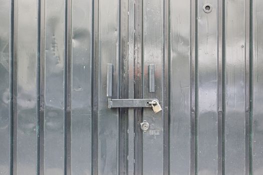 Bright green metal door, detail of a closed door, protection and security
