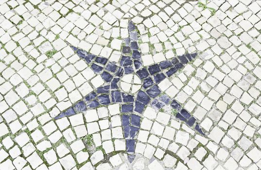 Star typical tiles from Lisbon, detail of a mosaic in a typical tourist street