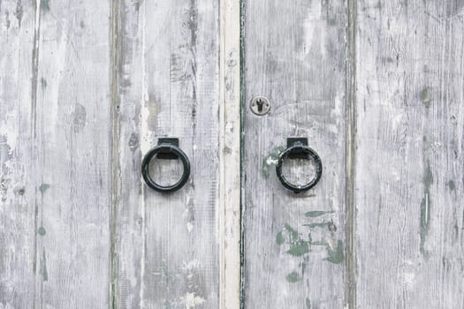 Old wooden door, detail of an old door damaged, security