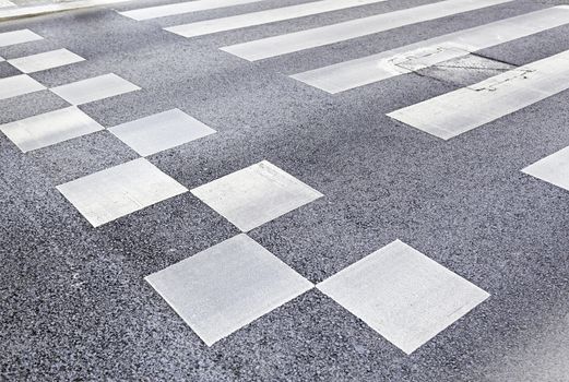 Zebra crossing in the city, detail of a crosswalk on a road, asphalt and safety