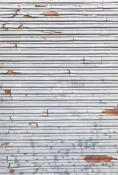 Chipped and rusty metal wall, detail of a down and dirty in ciuad wall, background with texture