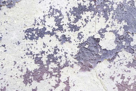 Abandoned peeling painted wall detail of an old ruined wall, background with texture