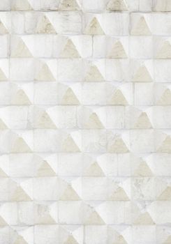 Stone wall with reliefs of triangle, background