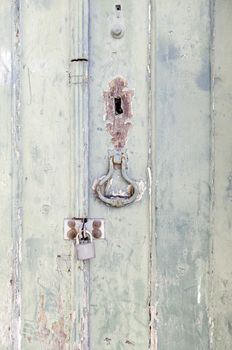 Door closed with wooden decoration, detail of a closed door with padlock, protection and security