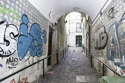 Old alley in Lisbon, detail of an old and battered city street, old town