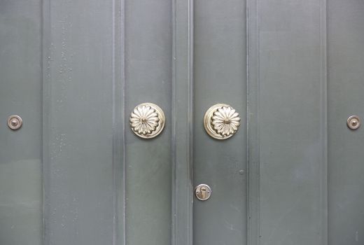 Wooden door with metal knockers, door detail of a decorated, safety and security