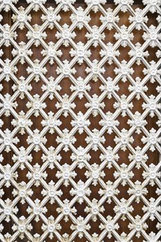 White metal fence, detail of a grille protection with decoration, security