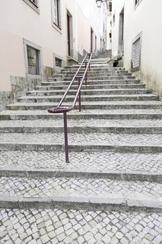 Ancient stairs on a street in Lisbon, detail of a stone staircase in an old street of Portugal