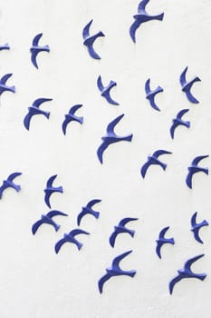 Birds on a wooden wall, detail of a wall decorated with figures of blue birds
