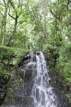 Waterfall in nature, detail of a natural waterfall, nature and environment