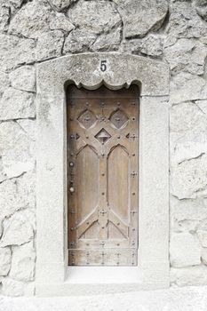 Old wooden door in a church, detail of a decorated door, protection and security