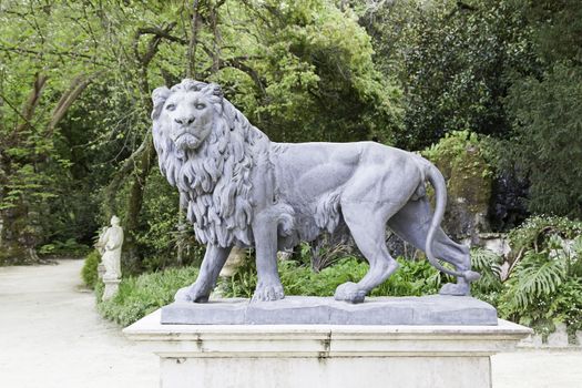 Lion statue in a garden, detail of a metal statue, outdoor art