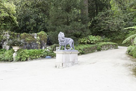 Lion statue in a garden, detail of a metal statue, outdoor art