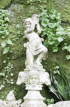 Stone statues in a garden in Sintra, detail of art in stone outdoors, tourism and art