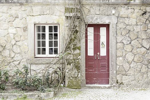 Door and window old, abandoned, detail of the facade of an old stone house