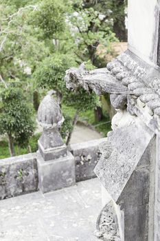 Old stone gargoyle in Portugal, detail of art in an old building, medieval