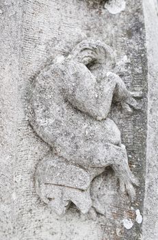 Old stone gargoyle in Portugal, detail of art in an old building, medieval