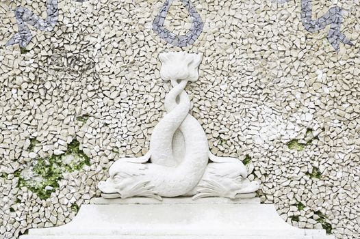 Detail of a stone bench with statues, ancient art in a garden of Portugal