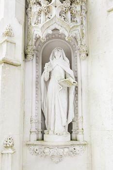 Statue of a virgin in stone, detail of religious art, Christian monument
