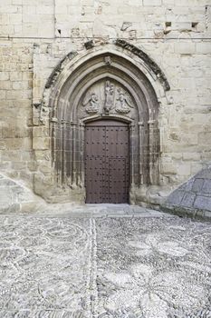 Old wooden door of a medieval church, detail of a decorated door, protecting, historic monument