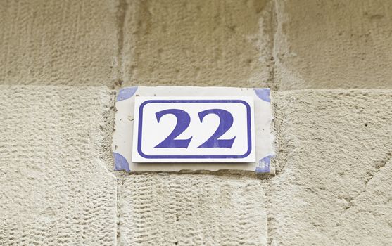 Number twenty on a wall, detail of a number of information on a street, text and number, even number