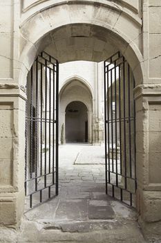 Old metal gate in a medieval church, detail of a door in a church abanonada ancient medieval monument
