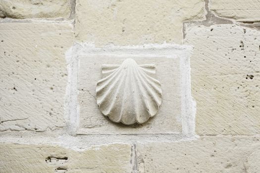 Shell pilgrims stone detail of a religious symbol for pilgrims, camino de santiago