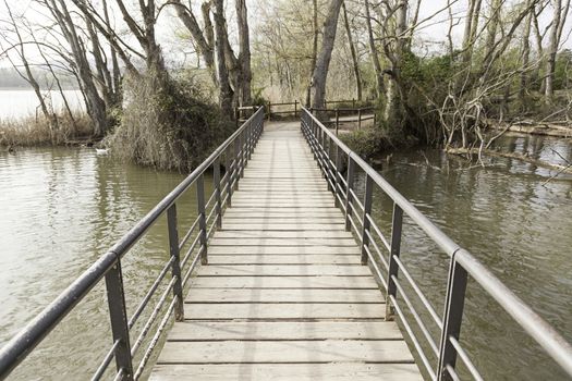 Old wooden bridge in a lake, detail of an old footbridge