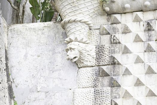 Old stone gargoyle in Portugal, detail of art in an old building, medieval